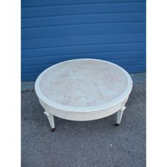 a white coffee table sitting in front of a blue wall