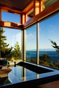 a room with large windows overlooking the ocean