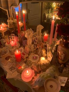 a table topped with lots of candles and pictures