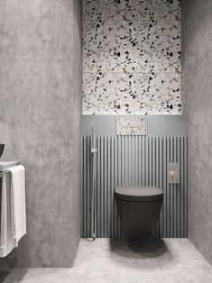 a bathroom with a toilet, sink and towel rack in the corner on the wall