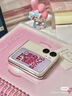 a cell phone sitting on top of a pink table