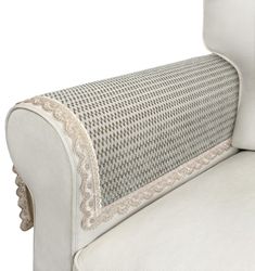 an upholstered white couch with beige trimming