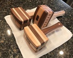 three wooden utensils sitting on top of a white napkin next to each other