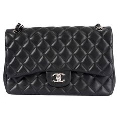 100% authentic Chanel Classic Large Timeless Double Flap shoulder bag in black lambskin featuring silver-tone hardware. Open pocket on the back. Closes with classic CC-turn-lock on the front. Zipper pocket inside the flap. Outside pocket on the front under the flap. Lined in burgundy leather with two open and a lipstick pocket against the back. CC stitching on the inside flap. Has been carried and shows soft wear to the corners. Overall in excellent condition. Comes with dust bag and box. Measur Black Quilt, Chanel Black, Lambskin Leather, Timeless Classic, Fashion Handbags, Chanel Classic, Front Zipper, Inside Pocket, Leather Shoulder Bag