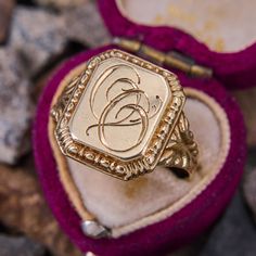 This antique signet ring features the initials "OO" in script on the rectangular shaped top. The shoulders are decorated with beautiful scrolling and patina. The ring is crafted in 14k yellow gold and is a size 10.5. We are not offering resizing due to the hand engraved inscription on the inside if the shank that reads "Minnie Fira Reidar de Wenke." Luxury Antique Signet Ring With Brilliant Cut, Luxury Vintage Diamond Cut Signet Ring, Luxury Engraved Victorian Signet Ring, Classic Engraved Signet Ring For Ceremonial Occasions, Classic Engraved Signet Ring For Ceremonial Use, Classic Engraved Ceremonial Signet Ring, Classic 14k Gold Signet Ring For Ceremonial Occasions, Classic Yellow Gold Signet Ring With Maker's Mark, Antique Signet Ring With Maker's Mark For Formal Occasion