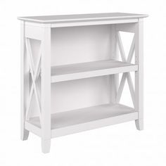 a white bookcase with two shelves on one side and an x design on the other