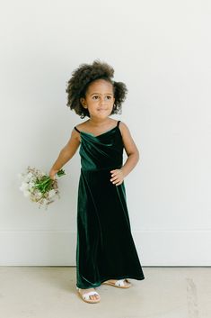 Our popular Skye Velvet dress now comes in our kids sizing and is a darling addition to match the bridal party! Kids Skye features a modest cowl neckline for more coverage and a simplistic silhouette perfect for any mini-me! Model Naveah; Size: 3T / Length: Regular, Age: 2, Height: 3'3 (measurements from 2021) FEATURES: A-line silhouette Cowl neckline Adjustable velvet spaghetti straps Side zipper Full-length double lining for extra coverage Flower Girls Dresses Dark Green, Flower Girl Green Dresses, Colorful Flower Girl Dresses, Forest Green Flower Girl Dress, Emerald Flower Girl Dress, Emerald Green Flower Girl Dress, Emerald Green Flower Girl, Country Flower Girl Dresses, Country Flower Girl