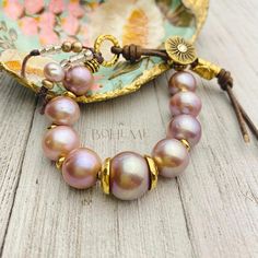 Unique, one-of-a-kind, beautiful pink pearl bracelet for women. What a fabulous gift for your loved one or maybe a little something for yourself. Nine large, 14mm lavender Edison pearls separated by small gold filled nugget beads with adjustable leather closure.  Only one available. This special piece is handmade in sunny Florida and ships quickly for you. Bohemian Pearl Bracelet For Jewelry Making, Bohemian Pink Beaded Pearl Bracelet, Adjustable Bohemian Bracelet With Pearl Charm, Bohemian Adjustable Bracelet With Pearl Charm, Bohemian Bracelets With Adjustable Pearl Charm, Bohemian Bracelet With Adjustable Pearl Charm, Mother's Day Pearl Bracelet With Round Beads, Bohemian Adjustable Pearl Bracelet, Elegant Pink Jewelry Hand Wrapped