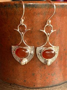 Carnelian and a pearl set in sterling silver in an art nouveau design make these earrings exquisite. A lovely romantic design that reminds me of regal gowns and forest adventures. Carnelian restores vitality and motivation, and stimulates creativity. It gives the wearer courage. Matched perfectly with pearl which is symbolic of the wisdom gained through experience. The perfect gift for Valentine's day for someone you love or admire. Elegant Carnelian Jewelry For Formal Occasions, Victorian Carnelian Jewelry For Formal Occasions, Unique Silver Pearl Earrings For Wedding, Vintage Carnelian Jewelry For Weddings, Vintage Carnelian Jewelry For Wedding, Silver Victorian Pearl Earrings For Anniversary, Victorian Silver Pearl Earrings For Anniversary, Silver Teardrop Carnelian Jewelry, Silver Carnelian Teardrop Jewelry