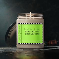 a candle is sitting on a table with a green label that says, befruitice