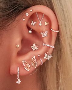 a woman's ear with many different types of piercings