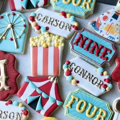 some decorated cookies are sitting on a table with carnival signs and other items around them