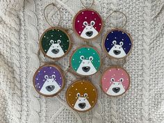 six decorated cookies are arranged in the shape of polar bear and snowman's faces