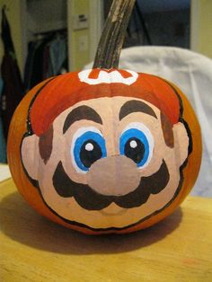 a painted pumpkin with a man's face on it