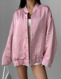 "Pink satin oversized bomber jacket is a stylish choice for any occasion!  Our bomber jacket with lined, has large patch pockets, and fastens with buttons at the front.  The jacket is universal and can be worn both casually for every day, combining with various styles of clothing, and for special occasions, complementing a holiday suit or evening dress.   DETAILS  - pink  - satin  - lined  - button closure  - oversized  - large front patch pockets   SIZES   This bomber jacket is oversized  Back Trendy Oversized Outerwear With Patch Pockets, Oversized Long Sleeve Varsity Jacket For Spring, Oversized Long Sleeve Spring Varsity Jacket, Oversized Long Sleeve Varsity Jacket With Pockets, Fall Varsity Jacket With Stand Collar And Pockets, Trendy Oversized Utility Jacket, Trendy Oversized Solid Color Utility Jacket, Oversized Solid Color Trendy Utility Jacket, Trendy Oversized Varsity Jacket With Ribbed Cuffs