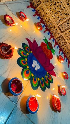 decorated diya with candles on the floor