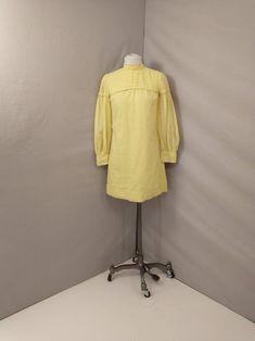 "Beautiful authentic 1960's mini dress. Super feminine period style. Quality construction with sheer overlay, Pintuck detailing at shoulders. Clear lemon yellow. No size tag, shown on a 6 mannequin, please go by measurements. Metal zipper back. Two layers except sleeves. Very good condition, no damage, light spot at neck some light rust marks from a hanger inside only. Length 33\" Shoulders 14.5\" Bust 36\" Waist 36\" Hips 38\" Hem circumference is 45\" Wt 8oz" Retro Mini Dress For Spring Daywear, Vintage Long Sleeve Mini Dress For Spring, Knee-length Retro Mini Dress For Daywear, Retro Knee-length Mini Dress For Daywear, Vintage Yellow Puff Sleeve Dress, Spring Yellow Vintage Dress For Daywear, Yellow Vintage Dress For Spring Daywear, Vintage Knee-length Spring Mini Dress, Vintage Knee-length Mini Dress For Spring