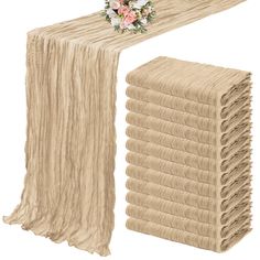 a stack of folded napkins next to a bouquet of flowers on a white background