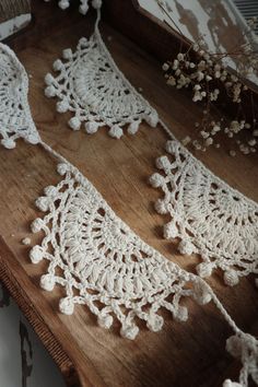 two white crocheted laces on a wooden table