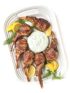 grilled chicken with lemon wedges and dill dip