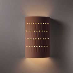 a light that is on the side of a wall in a room with grey walls