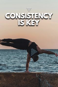 a man doing a handstand in front of the ocean with text that reads, constency is key