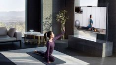 a woman is doing yoga in the living room