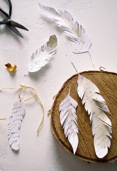 some paper feathers and scissors on a table