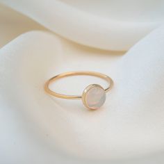 Featuring a stunning 5mm hand picked Australian Opal. Each stone is unique and since these are natural Opals, no two stones will ever be alike. This ring is handmade with a 14k Gold filled ring and a stunning natural opal set in a gold filled bezel. Material: 14k Gold filled Natural Australian Opal Classic Opal Moonstone Ring As Gift, Everyday Opal Jewelry With Gemstones, Everyday Opal Gemstone Jewelry, Si Clarity Moonstone Wedding Jewelry, Wedding Moonstone Jewelry With Si Clarity, Adjustable 14k Yellow Gold Moonstone Ring, 14k Gold Round Opal Halo Ring, 14k Gold Opal Ring With Halo, Classic Opal Rings With Birthstone