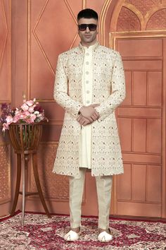 Welcome to Grooms World collection of Sherwani and indo western   Introducing our exquisite Groom's Sherwani, meticulously crafted with intricate computer thread work on art silk, perfect for your special day. This stunning 3-piece jacket set features a regal Aligadhi pant, complementing the traditional elegance of Indian attire. Elevate your wedding ensemble with this luxurious sherwani, designed to make you stand out on your big day. Whether it's the richness of the fabric, the impeccable deta Festive Cream Sherwani For Groom, Long Semi-stitched Nehru Jacket For Wedding, Traditional Sherwani For Ceremonies And Festivals, Traditional Sherwani For Diwali Ceremony, Ceremonial Sherwani With Traditional Drape, Festive Ceremony Kurta With Chikankari Embroidery, Traditional Sherwani With Chikankari Embroidery For Ceremony, Fitted Sherwani With Pallu For Ceremony, Chikankari Embroidery Sherwani For Groom In Festivals