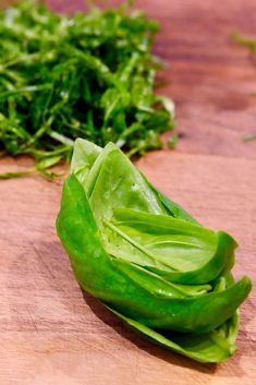 some green leafy vegetables on a cutting board