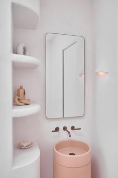 a bathroom with a sink, mirror and shelves