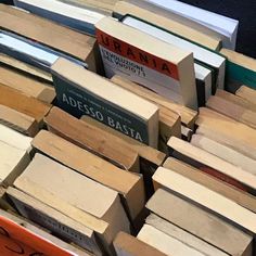 there are many books stacked on top of each other in this pile, all different colors and sizes