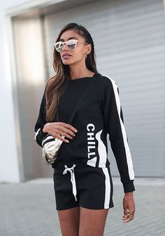 Loungewear shorts with a drawstring waistband. Casual Sweats For Lounging, Black Relaxed Fit Top For Leisure, Casual Cotton Sweatshirt For Lounging, Trendy Black Sweatshirt For Fall, Trendy Black Sweats With Ribbed Cuffs, Black Casual Sweater With Ribbed Cuffs, Black Top For Lounging In Fall, Trendy Stretch Cotton Sweatshirt, Black Relaxed Fit Sweats