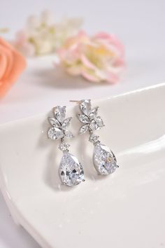 "These cubic zirconia bridal earrings are stunning for bridal occasions whether you want a vintage or classic look. They are made with high quality AAA+ cubic zirconia that glistens on the ear. They come in a sparkling silver and rose gold finish to give an elegant look. These gorgeous earrings will be carefully wrapped and arrive in a logo gift box. Visit my shop for care instructions and more bridal accessories ➔ https://www.etsy.com/shop/BlushandIvoryStudio Measurements: ► Length: 1.5\" or 3. Cubic Zirconia Bridal Earrings, Chandelier Long, Bridal Stud Earrings, Drop Bridal Earrings, Long Bridal Earrings, Bridal Earrings Studs, Bridal Earrings Chandelier, Earrings Chandelier, Bridal Earrings Drop