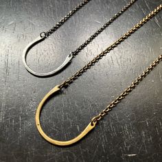 This simple necklace resembles a horse shoe and serves as a ring holder. I had a request from a massage therapist, she wanted a necklace that she could hang her wedding ring from so she could have her hands free. Great on it's own or with long layers! (RING IN PHOTO NOT INCLUDED) 1" wide, 16" sterling/ brass chain Available in 2 metals:- Silver - Brass Minimalist Hoop Jewelry With Adjustable Chain, Minimalist Adjustable Oval Necklaces, Classic Crescent Jewelry As A Gift, Classic Crescent Jewelry For Gifts, Classic Crescent Jewelry For Gift, Classic Crescent Jewelry Gift, Classic Crescent-shaped Gift Jewelry, Simple Oval Everyday Jewelry, Simple Everyday Oval Jewelry