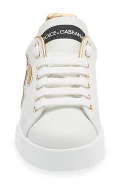 This street-smart leather sneaker kicks your casual ensembles up a notch with iconic logo detailing highlighted by a metallic finish. Lace-up style Removable insole Leather upper and lining/synthetic sole Made in Italy Women's Designer Shoes Luxury Low-top Sneakers With Metallic Logo, White Sole Leather Sneakers With Metallic Logo, Luxury High-top Sneakers With Logo, Luxury Leather Sneakers With Metallic Logo, Luxury Low-top Sneakers With Logo, Classic Gold Sneakers For Streetwear, Trendy Sneakers With Logo And White Sole, Luxury White High-top Sneakers With Logo, Designer Low-top Sneakers With Logo Detail