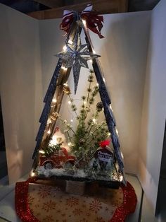 a small christmas tree with lights and decorations