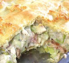 a casserole with meat, cheese and vegetables is being cooked in a skillet