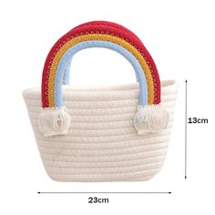 a white basket with a red, yellow and blue handle is shown in front of the measurements