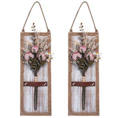 two wall hangings decorated with flowers and twine rope hang from the side on white wood planks