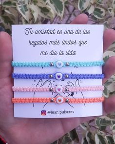 three bracelets with beads and charms on them in front of a card that says,