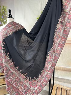 A Kani Doli Barat At shawl is a regal and exquisite piece of traditional Kashmiri craftsmanship. Woven using the intricate Kani weaving technique, this shawl showcases a finely detailed pattern of doli barat, symbolizing the traditional wedding processions. The shawl is crafted from luxurious fine wool, renowned for its softness and warmth. The intricate designs are created using small, colorful threads, meticulously woven into the fabric. The Kani Doli Bar At shawl is not just a fashion accesso Kashmiri Wedding, Colorful Threads, Wedding Procession, Scarf Hijab, Kashmiri Shawls, Wool Shawl, Shawl Scarf, Intricate Designs, Traditional Wedding