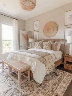 a large bed sitting in a bedroom next to a window