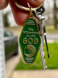 a person holding a keychain that says the wildwoods, n y usa