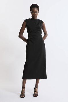 Feel Formal In Our Midi Dress, Which Features A Draped Design And A Fit That Skims The Curves. The Straight Hanging Skirt Features A Leg Split In The Back, And The High Neckline Makes This Piece Ideal For Office Days And Formal Events. Style It With Court Heels Or Strappy Stilettos For A Look Ideal For Anything From Work Days To Dinner Dates. Structured Crepe Asymmetric Drape Waist Tailored Midi Dress High Quality Crepe Fabric Flattering, Fitted Silhouette Draped Waist Design High Neckline Zip B Black Asymmetrical Midi Dress For Office, Black Asymmetrical Dress For Work With Asymmetrical Neckline, Fitted Midi Dress With Asymmetrical Hem For Work, Black Sleeveless Dress With Asymmetrical Neckline For Formal Occasion, Black Sleeveless Asymmetrical Dress For Work, Black Knee-length Asymmetrical Dress For Work, Black Asymmetrical Hem Midi Dress For Work, Sleeveless Midi Dress With Structured Shoulders For Work, Black Dress With Asymmetrical Hem For Work