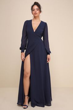 a woman in a long blue dress with a slit down the side and an open neckline