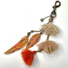 three feathers and beads hanging from a key chain