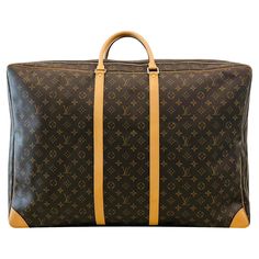 Louis Vuitton LV Monogram Coated Canvas Sirius 70 Travel Bag Brown suitcase crafted in coated canvas designed with the brand's signature LV monogram. Detailed with natural leather trims and rounded leather handles. Featuring golden brass branded hardware, padlock with keys and removable leather ID holder. Size – Height 50cm, Width 70cm, Depth 25cm Condition – Very Good (Small signs of use) Composition – Coated Canvas, Leather Comes with –Dust Bag Leather Trunk, Louis Vuitton Store, Leather Travel Bag, Vintage Monogram, Lv Monogram, Louis Vuitton Shoulder Bag, Small Signs, Vintage Louis Vuitton, Canvas Designs