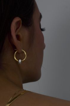 The classic gold hoop reinvented. Crafted in high polish 18K Gold vermeil with sterling silver accent, the Greyson hoops are a staple in the Hydez Essential Collection. These sophisticated head-turners will luxe up any look. Our two tone design means you’ll never have to choose between gold and silver.Materials: 18K Gold Vermeil and Sterling SilverDimensions: 20mm hoop, 3mm width What is 18K Gold Vermeil?: 3 microns of 18K Gold over Sterling Silver. Vermeil is far more durable to wear than tradi Minimalist Gold Jewelry With Bail, Gold Tarnish-resistant Huggie Earrings For Anniversary, Minimalist Hallmarked Huggie Earrings For Anniversary, Silver Polished Gold-plated Hoop Earrings, Luxury Gold Sterling Silver Hoop Earrings, Everyday Luxury Gold Hoop Huggie Earrings, Gold Huggie Earrings For Anniversary, Timeless White Gold Tarnish Resistant Hoop Earrings, Timeless Tarnish-resistant White Gold Hoop Earrings